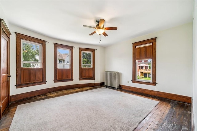 520 Morrell Ave, Connellsville, PA 15425 - unfurnished room with radiator heating unit, a ceiling fan, and dark wood finished floors