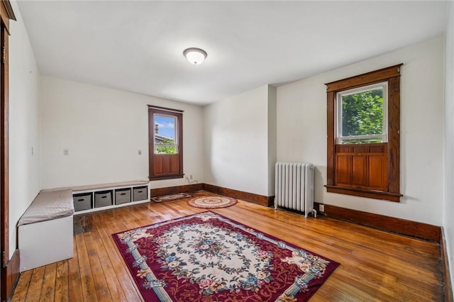 520 Morrell Ave, Connellsville, PA 15425 - unfurnished room featuring radiator heating unit, healthy amount of natural light, and hardwood / wood-style flooring