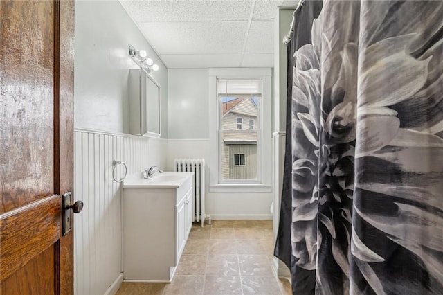 520 Morrell Ave, Connellsville, PA 15425 - bathroom featuring radiator, vanity, a wainscoted wall, tile patterned floors, and a paneled ceiling