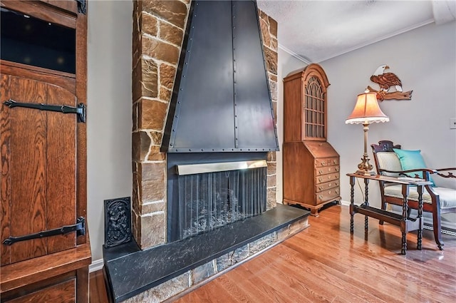 4735 Pine Cone Dr, Hermitage, PA 16148 - detailed view of a stone fireplace, wood finished floors, and crown molding