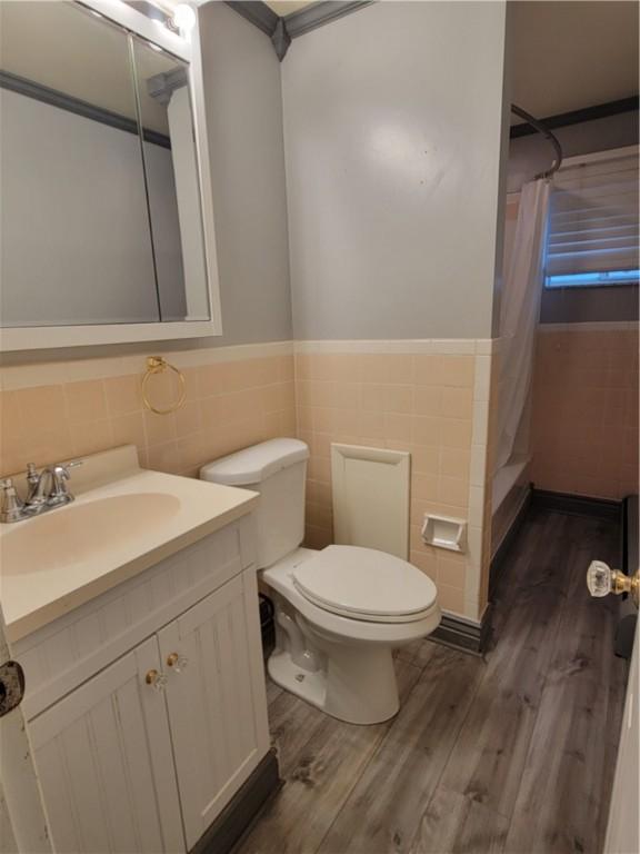 778 Millers Run Rd, Mcdonald Nwa, PA 15057 - bathroom featuring tile walls, wood finished floors, vanity, wainscoting, and curtained shower