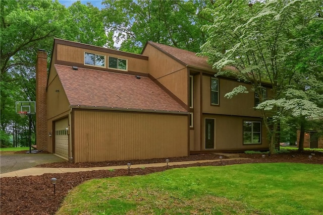 1259 Lakevue Dr, Penn Twp, PA 16001 - view of front of property with a chimney, a garage, roof with shingles, a front yard, and driveway