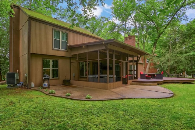 1259 Lakevue Dr, Penn Twp, PA 16001 - back of property with a sunroom, a chimney, a patio area, a lawn, and a wooden deck