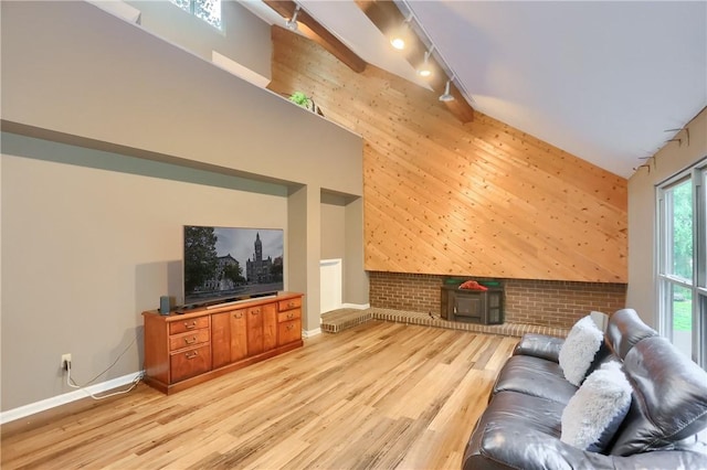 1259 Lakevue Dr, Penn Twp, PA 16001 - living area featuring track lighting, light wood finished floors, high vaulted ceiling, and an accent wall