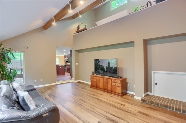 1259 Lakevue Dr, Penn Twp, PA 16001 - living room with rail lighting, light wood finished floors, beam ceiling, and high vaulted ceiling