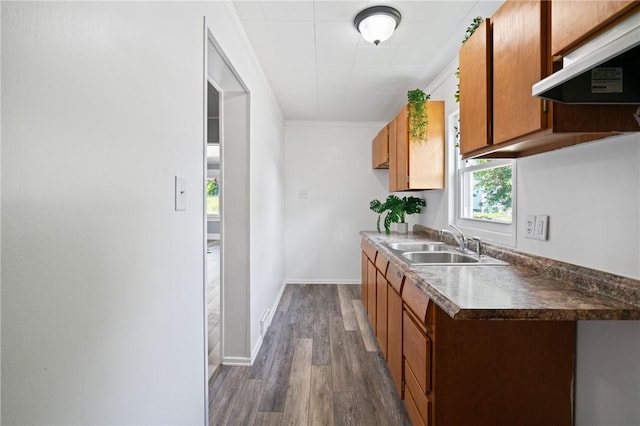 1723 Kimball Ave, Arnold, PA 15068 - kitchen featuring ventilation hood, dark wood finished floors, brown cabinets, ornamental molding, and dark countertops