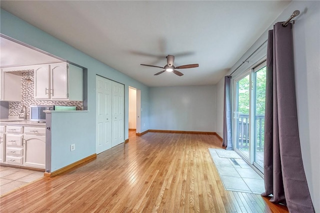 413 Allenberry Dr, Ross Twp, PA 15237 - unfurnished living room with ceiling fan and light wood-style flooring