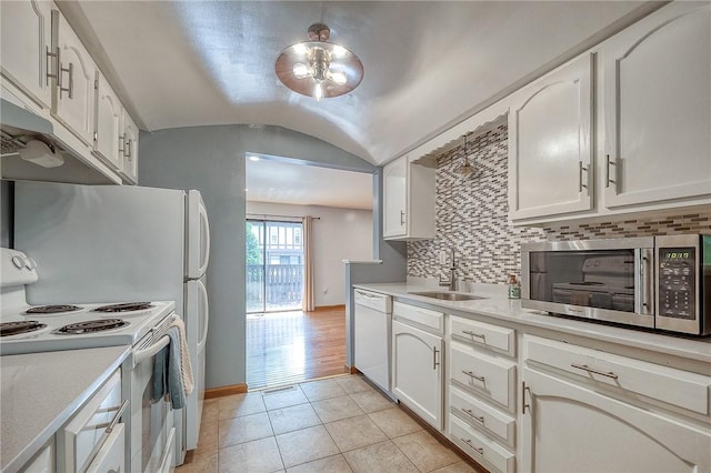 413 Allenberry Dr, Ross Twp, PA 15237 - kitchen featuring white appliances, light tile patterned floors, decorative backsplash, light countertops, and lofted ceiling
