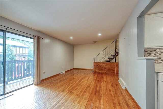 413 Allenberry Dr, Ross Twp, PA 15237 - unfurnished living room with light wood finished floors, stairway, and recessed lighting