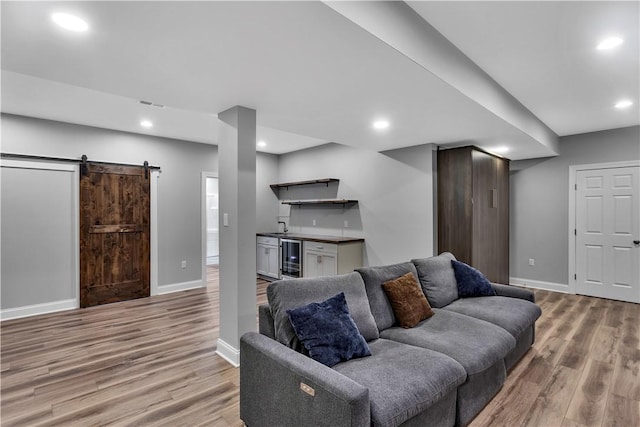 413 Cayuga Cir, Marshall, PA 16046 - living area with bar with sink, wine cooler, light wood-type flooring, a barn door, and recessed lighting
