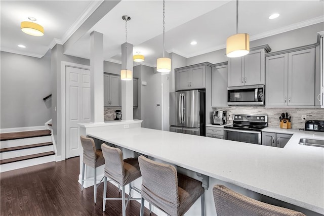 413 Cayuga Cir, Marshall, PA 16046 - kitchen with appliances with stainless steel finishes, gray cabinetry, ornamental molding, decorative backsplash, and dark wood-type flooring