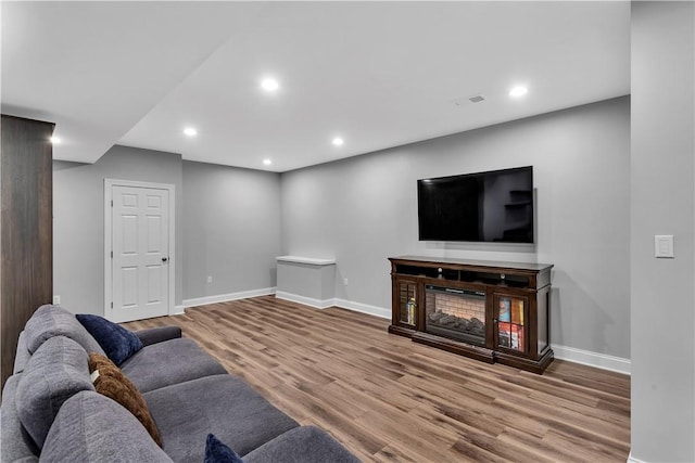 413 Cayuga Cir, Marshall, PA 16046 - living room featuring wood finished floors, recessed lighting, and a glass covered fireplace