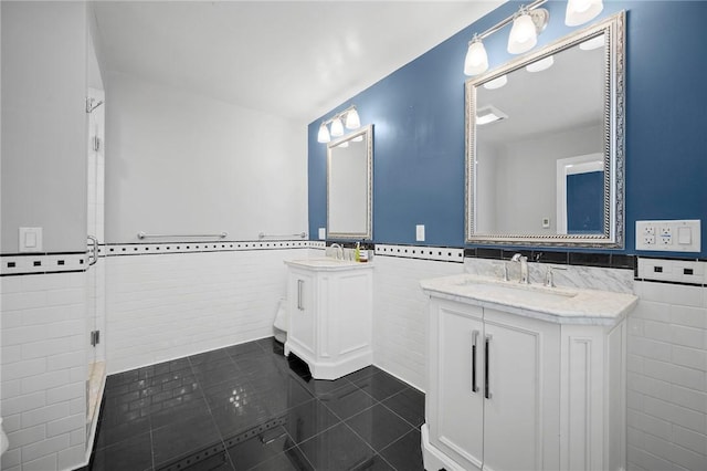 215 Emerson St, Shadyside, PA 15206 - full bathroom featuring tile walls, wainscoting, vanity, tile patterned floors, and an enclosed shower