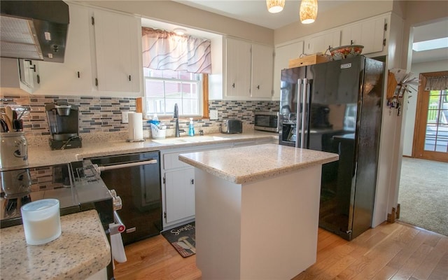 32 Dunham Dr, Hempfield Twp Wml, PA 15601 - kitchen with appliances with stainless steel finishes, extractor fan, light wood finished floors, a kitchen island, and white cabinets