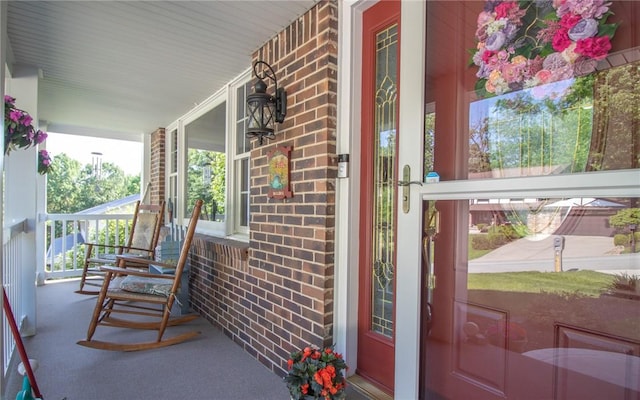 32 Dunham Dr, Hempfield Twp Wml, PA 15601 - doorway to property featuring a porch and brick siding