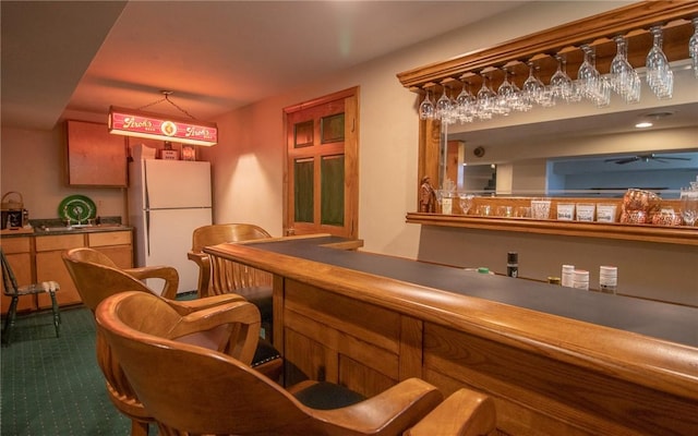 32 Dunham Dr, Hempfield Twp Wml, PA 15601 - indoor dry bar with freestanding refrigerator and dark carpet