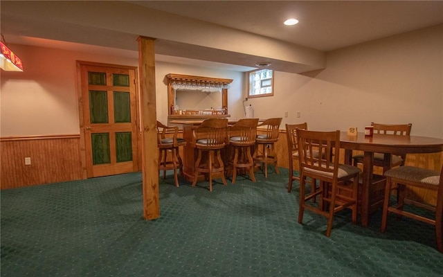 32 Dunham Dr, Hempfield Twp Wml, PA 15601 - dining room with bar, a wainscoted wall, wood walls, carpet flooring, and recessed lighting