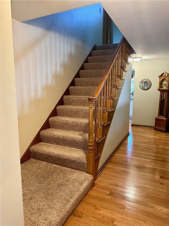 32 Dunham Dr, Hempfield Twp Wml, PA 15601 - staircase with wood finished floors and baseboards