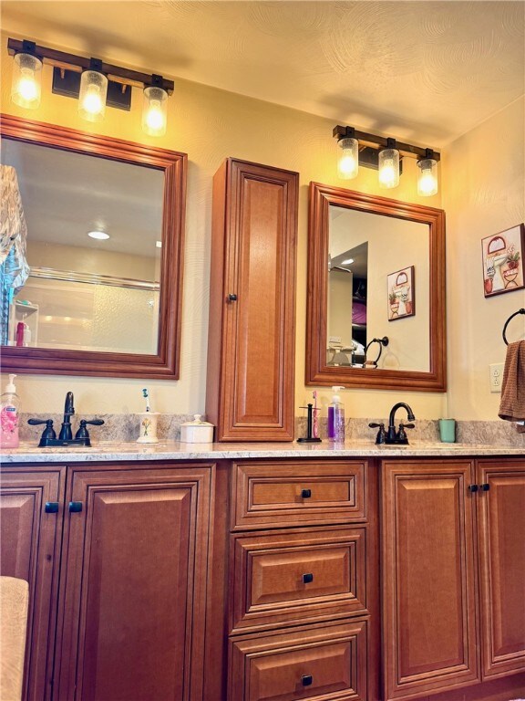 32 Dunham Dr, Hempfield Twp Wml, PA 15601 - bathroom with double vanity and a shower