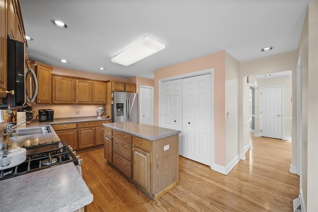 110 Northgate, West Mifflin, PA 15122 - kitchen featuring appliances with stainless steel finishes, light wood-type flooring, brown cabinets, a center island, and recessed lighting