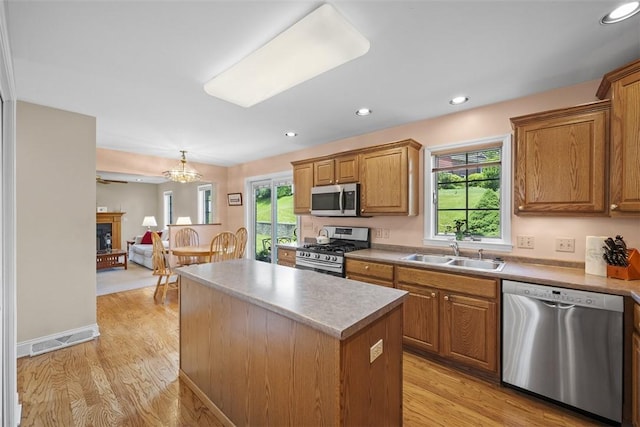 110 Northgate, West Mifflin, PA 15122 - kitchen featuring stainless steel appliances, a center island, light wood-type flooring, brown cabinets, and recessed lighting