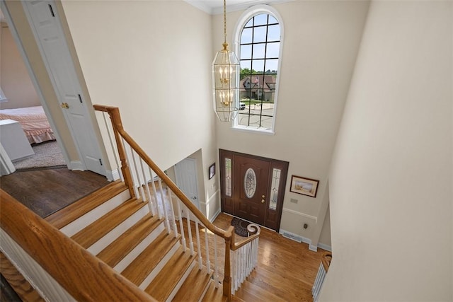 110 Northgate, West Mifflin, PA 15122 - entrance foyer featuring a chandelier, wood finished floors, a towering ceiling, and crown molding