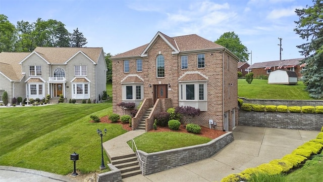 110 Northgate, West Mifflin, PA 15122 - view of front facade with brick siding, an attached garage, driveway, and a front yard