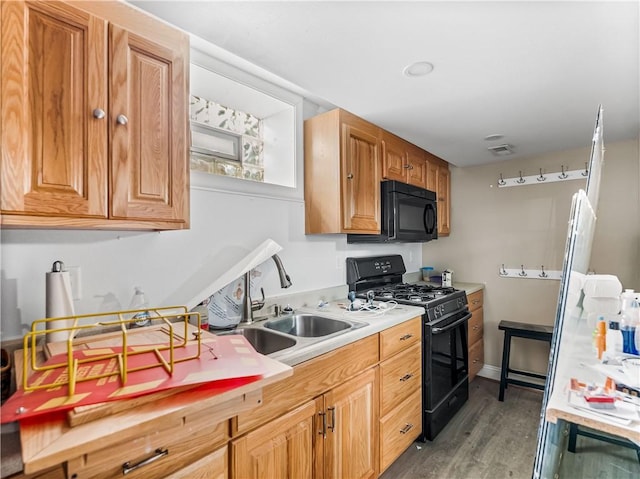 1556 Island Ave, Stowe Twp, PA 15136 - kitchen with black appliances, light countertops, and light wood-style flooring