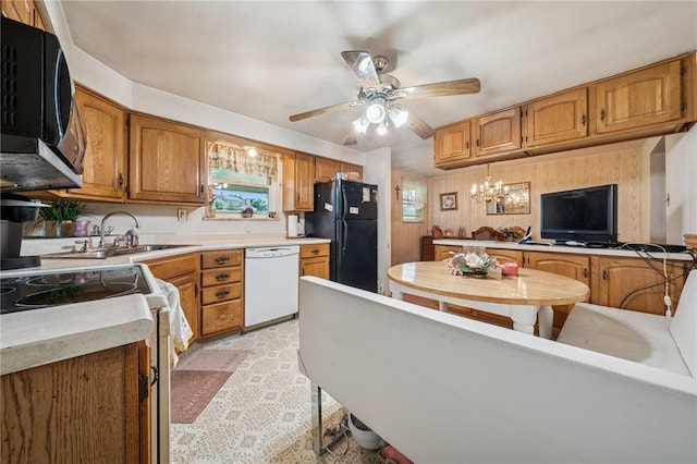 23 Corbett Ave, Hempfield Twp Wml, PA 15642 - kitchen with black appliances, ceiling fan, brown cabinetry, light countertops, and a chandelier