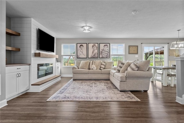 226 Stevens Ct, South Strabane, PA 15301 - living area featuring a fireplace, plenty of natural light, and dark wood-style flooring