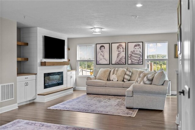 226 Stevens Ct, South Strabane, PA 15301 - living room with wood finished floors, a glass covered fireplace, and recessed lighting
