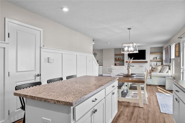 226 Stevens Ct, South Strabane, PA 15301 - kitchen with light wood-style floors, a kitchen island, open floor plan, white cabinets, and light countertops