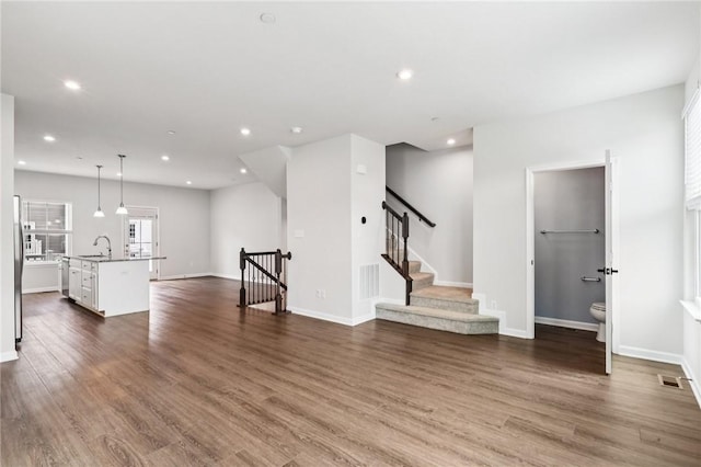 489 Nolan Cir, Cranberry Twp, PA 16066 - unfurnished living room with recessed lighting, dark wood-style flooring, and stairway
