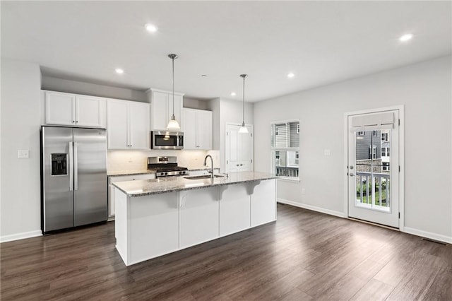 489 Nolan Cir, Cranberry Twp, PA 16066 - kitchen featuring stainless steel appliances, dark wood-style flooring, an island with sink, light stone countertops, and recessed lighting