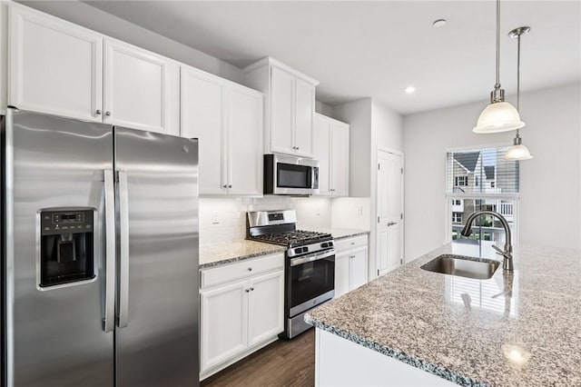 489 Nolan Cir, Cranberry Twp, PA 16066 - kitchen featuring appliances with stainless steel finishes, backsplash, light stone countertops, dark wood finished floors, and white cabinetry