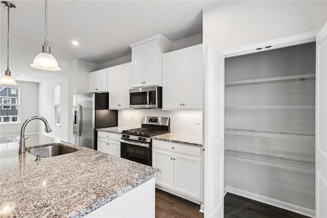 489 Nolan Cir, Cranberry Twp, PA 16066 - kitchen featuring stainless steel appliances, white cabinets, dark wood finished floors, decorative light fixtures, and backsplash