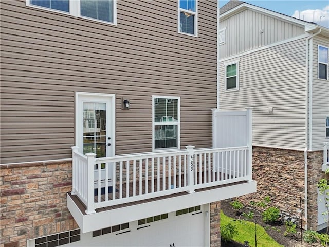 489 Nolan Cir, Cranberry Twp, PA 16066 - rear view of house featuring a garage, stone siding, and a balcony