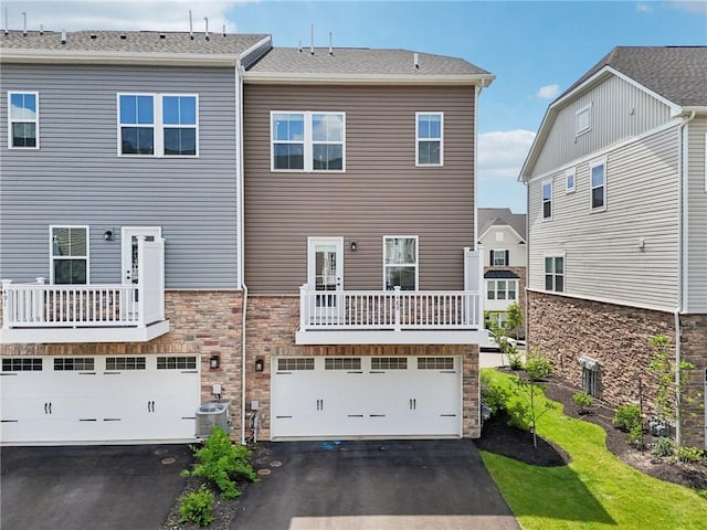 489 Nolan Cir, Cranberry Twp, PA 16066 - rear view of house featuring driveway, stone siding, and an attached garage
