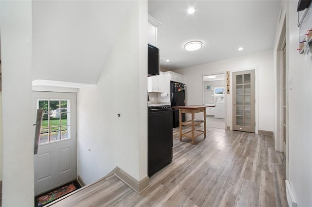 1431 Monastery Dr, Latrobe, PA 15650 - kitchen with white cabinetry, light wood-style floors, freestanding refrigerator, stove, and recessed lighting