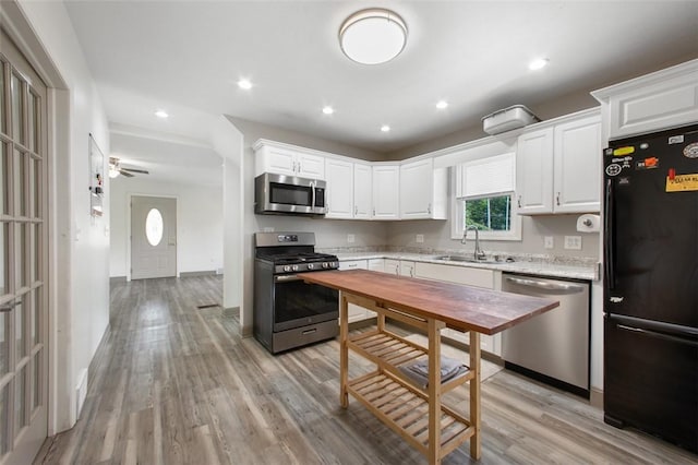 1431 Monastery Dr, Latrobe, PA 15650 - kitchen featuring stainless steel appliances, light wood-type flooring, white cabinets, recessed lighting, and a ceiling fan