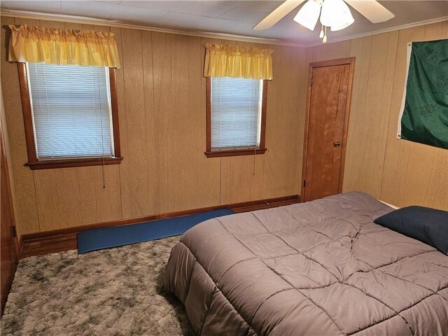 418 S Main St, Slippery Rock Boro, PA 16057 - bedroom with crown molding, carpet flooring, wood walls, and ceiling fan