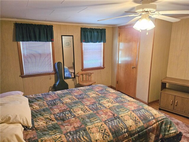 418 S Main St, Slippery Rock Boro, PA 16057 - bedroom with wood walls, a ceiling fan, and ornamental molding