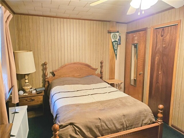 418 S Main St, Slippery Rock Boro, PA 16057 - carpeted bedroom featuring wood walls and a ceiling fan