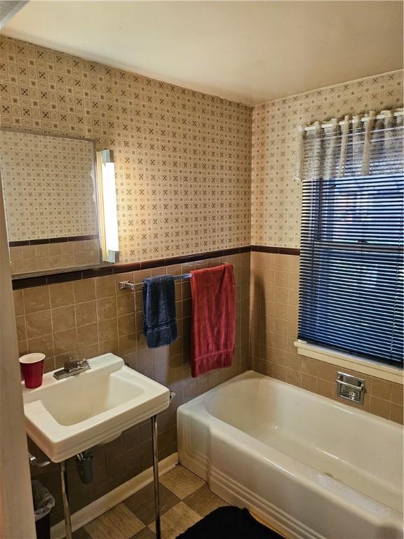 418 S Main St, Slippery Rock Boro, PA 16057 - full bathroom featuring tile walls, a bath, and a wainscoted wall