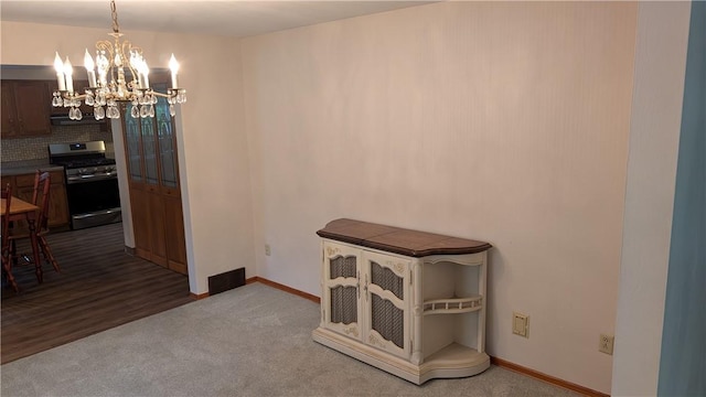 11297 Highpoint Dr, Penn Hills, PA 15235 - carpeted dining space featuring a chandelier and baseboards