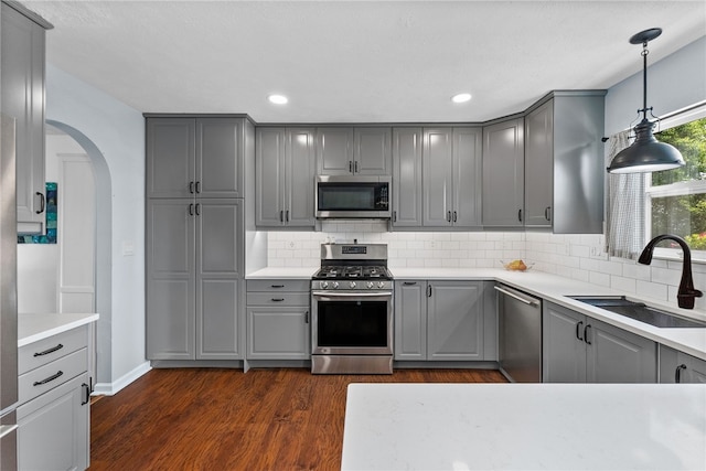 1020 Granite Dr, South Fayette, PA 15057 - kitchen with gray cabinetry, stainless steel appliances, arched walkways, tasteful backsplash, and recessed lighting