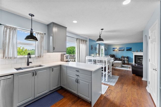 1020 Granite Dr, South Fayette, PA 15057 - kitchen with gray cabinetry, dishwasher, a peninsula, dark wood-style floors, and decorative backsplash