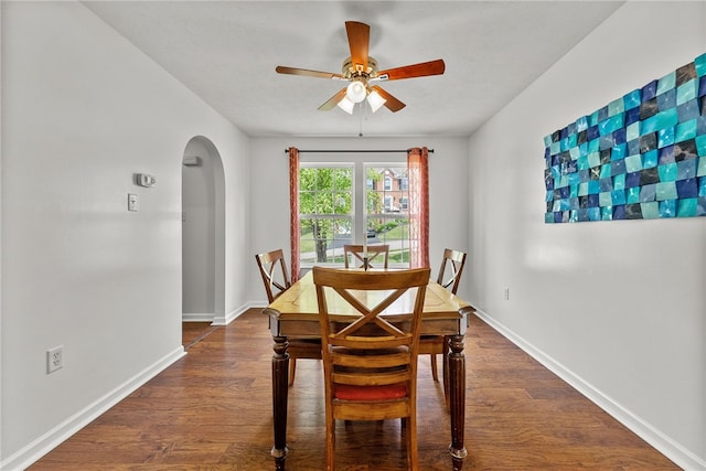 1020 Granite Dr, South Fayette, PA 15057 - dining room featuring arched walkways, a ceiling fan, and dark wood-style floors