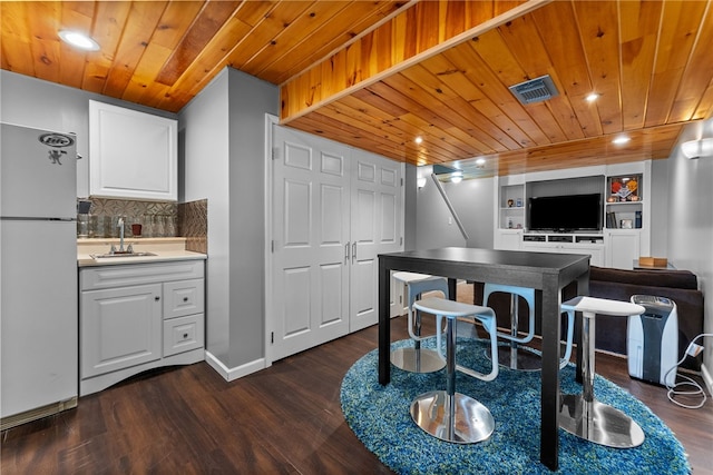 1020 Granite Dr, South Fayette, PA 15057 - kitchen with freestanding refrigerator, wood ceiling, dark wood-style flooring, white cabinets, and recessed lighting