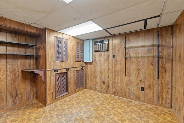 1031 Stratmore St, Ingram, PA 15205 - finished basement featuring wooden walls, a drop ceiling, a wall unit AC, and parquet floors